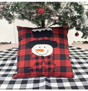 Christmas snowman embroidery on red and black plaid pillowcase under a festive tree