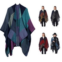 Detail view of colorful knitted poncho featuring blue, green, purple, and grey color blocks