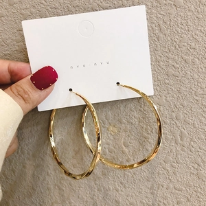 Exaggerated gold geometric hoop earrings with twisted metal texture for women