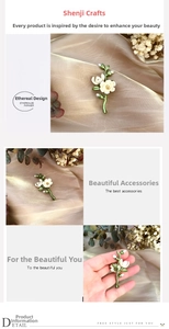 Detail of vintage enamel camellia brooch with freshwater pearls and green leaf accents