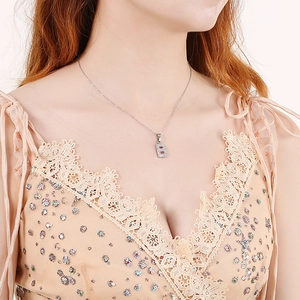 Elegant silver letter B necklace with sparkling pavé crystals for women on a model