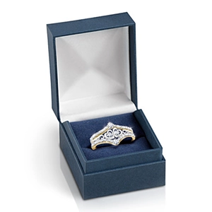 Two-tone heart crown ring with sparkling crystals in a blue gift box on white background
