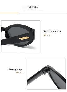 Détail de lunettes de soleil œil de chat noires avec accents dorés et charnières solides