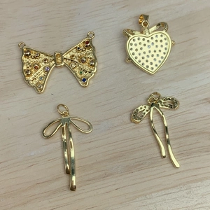 Golden bow and heart charms with micro-pave zircon crystals for DIY jewelry making