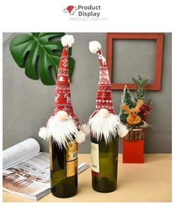 Detail of Christmas wine bottle covers featuring knitted gnome with snowflake and reindeer motifs