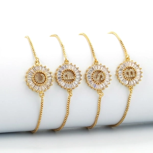 Adjustable gold plated letter bracelets with zircon pavé round pendants set on white props