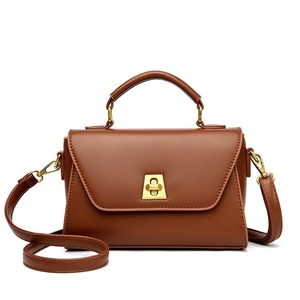 Classic brown trapezoid handbag with a golden lock and detachable crossbody strap