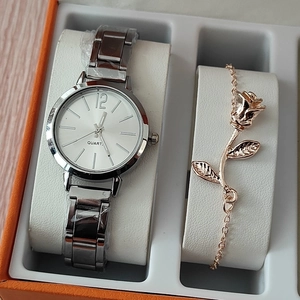 Women's silver quartz watch with a rose gold floral bracelet in a luxury display box