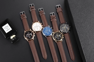 Detail view of quartz watches featuring leather straps and multi-color roman dial displays