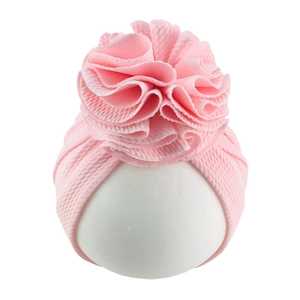 Detail showing the pink waffle texture fabric and large flower on infant turban hat