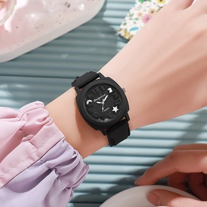 Fashionable black square quartz watch with embossed silicone strap on a female wrist