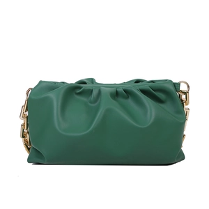 Detail of green pleated dumpling bag featuring soft PU leather and chunky gold chain straps