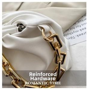 Detail of the white pleated cloud bag showing the polished gold chain and hardware