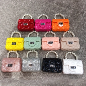 Mini PVC jelly bags with pearl handles and quilted texture in eleven vibrant colors