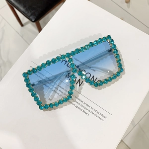 Macro view of blue gradient lens and crystal rhinestones on square sunglasses