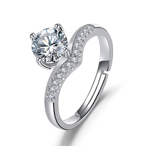 Macro shot of silver six-prong wedding ring with heart and arrow zircon and adjustable band