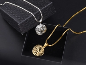 Detail of vintage gold and silver Roman coin necklaces in a premium black gift box