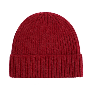 Detailed view of dark red ribbed knit texture on a warm winter beanie hat