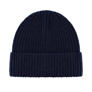 Detailed close-up of navy blue knit beanie featuring ribbed texture and folded cuff edge