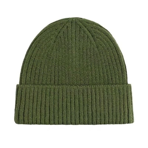 Close-up of dark green ribbed knit beanie showing high-quality fabric texture
