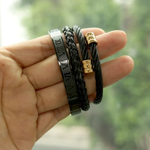 Detail of three-piece men's bracelet set with Roman numerals and woven textures on wrist