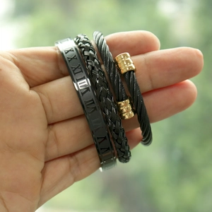 Detail of Roman numeral engraved bangle and braided steel rope bracelets for men