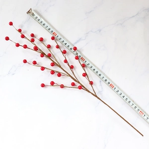 Artificial red berry branch 42cm length for home decor on white marble background