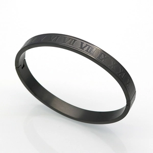 Detail shot of black matte titanium steel bracelet featuring engraved Roman numerals