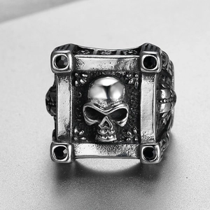 Men's gothic skull ring in vintage silver finish with four black gemstones on a square face