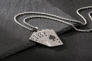Close-up of iced out silver Royal Flush poker cards pendant with sparkling zircons