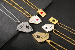 Close-up of hip-hop Ace of Hearts and Spades poker pendants with zircons and twist chains