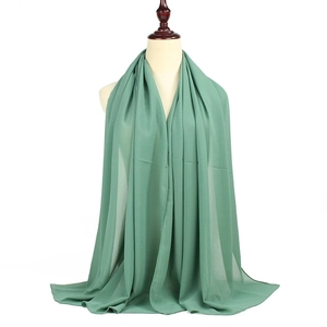 Classic green solid pearl chiffon hijab long scarf wrap shown on mannequin in studio