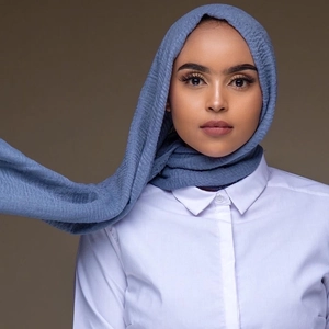 Close-up of crinkle texture on a greyish-blue cotton hijab paired with white shirt