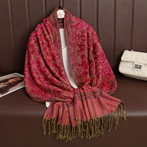 Detailed view of red ethnic paisley cashmere scarf with classic tassel fringes