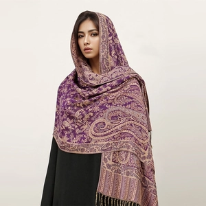 Close-up of purple and beige paisley cashmere-like shawl with elegant fringe tassels