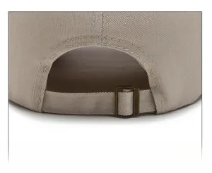 Detail of adjustable metal buckle and cotton fabric texture on beige baseball cap