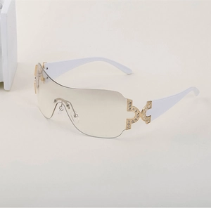 Close-up of Y2K rimless sunglasses featuring sparkling rhinestones and white temples