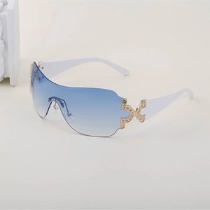 Close-up of Y2k rimless sunglasses with blue gradient lenses and rhinestone-set hinges