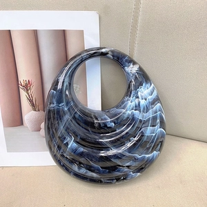 Minimalist acrylic handbag with blue marble texture in a creative crescent shape