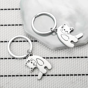 Matching silver cat couple keychains with minimalist heart-shaped interlocking design