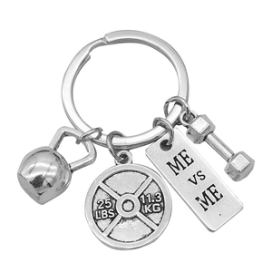 Silver fitness keychain with dumbbell, kettlebell and Me vs Me motivational plate