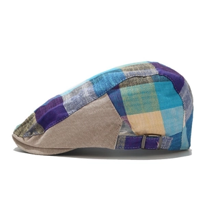 Side view of plaid beret hat featuring adjustable buckle strap and multi-color pattern