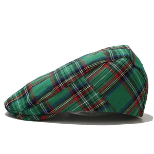 Side view detail of a classic green plaid flat cap with multi-color check pattern