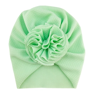 Detailed view of mint green waffle knit baby turban hat with a large handmade floral accent