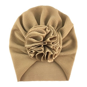Detail of khaki waffle fabric baby turban hat with oversized 3D flower decoration