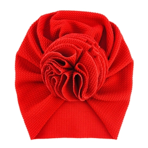 Infant waffle knit turban hat in bright red featuring a large 3D flower decoration