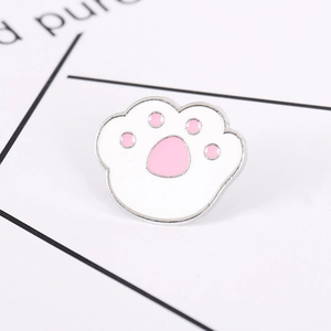 Cute white and pink cat paw alloy brooch pin displayed on a minimalist white card base