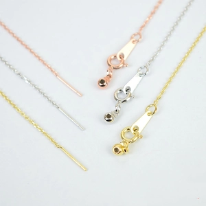 Macro detail of adjustable steel jewelry extenders with spring clasps and needle ends