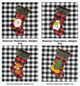 Detail of four plaid Christmas stockings with faux fur trim and festive 3D appliqués