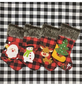 Detailed view of 4-piece plaid Christmas stockings with plush fur and festive 3D appliques